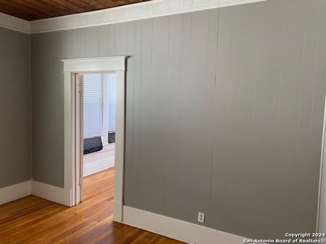 spare room featuring hardwood / wood-style floors and wood ceiling