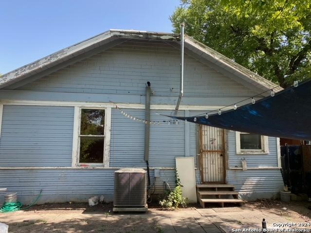 back of house featuring central AC unit