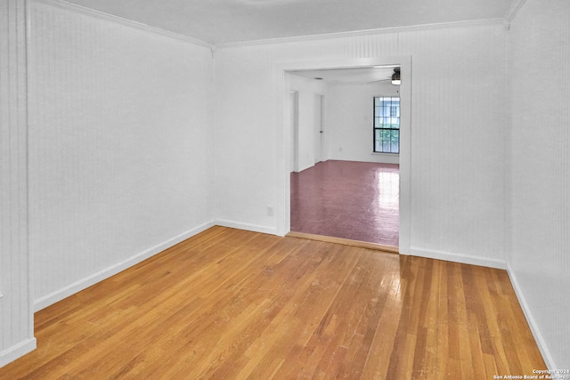 unfurnished room with light hardwood / wood-style floors, ornamental molding, and ceiling fan