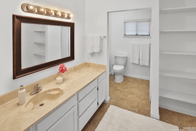 bathroom featuring vanity, toilet, and tile patterned floors