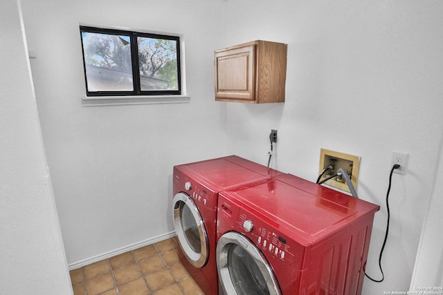 washroom featuring cabinets, independent washer and dryer, and tile patterned floors