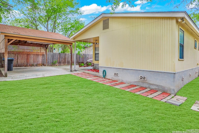 view of home's exterior with a patio area and a lawn