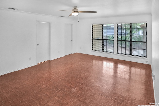 empty room with dark parquet flooring, crown molding, and ceiling fan