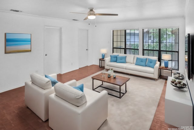 living room featuring wood-type flooring, crown molding, and ceiling fan