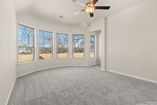 carpeted spare room featuring ceiling fan and vaulted ceiling