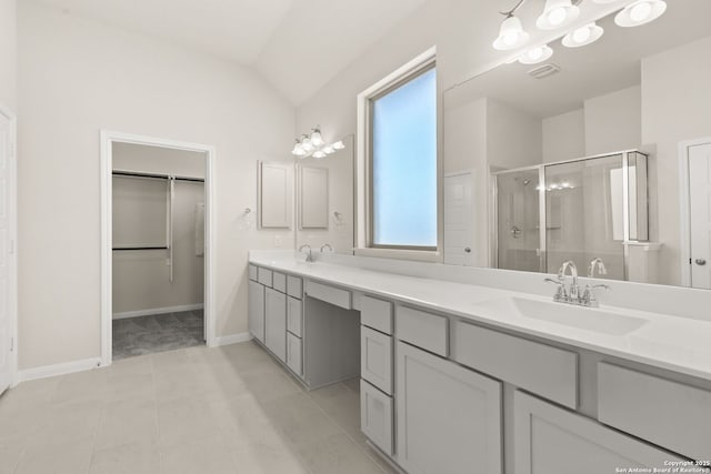 bathroom featuring lofted ceiling, an enclosed shower, and vanity