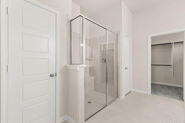 bathroom featuring an enclosed shower and tile patterned floors