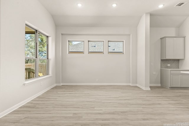 empty room with light hardwood / wood-style flooring