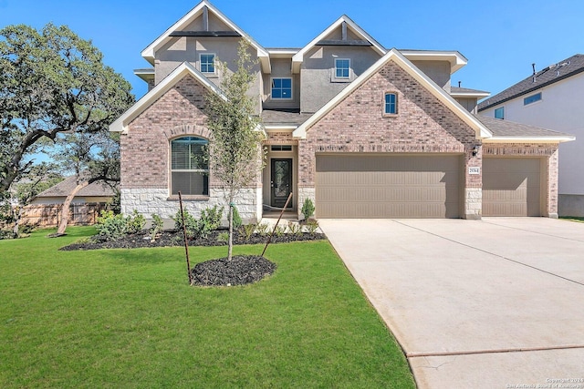 craftsman house with a front yard and a garage