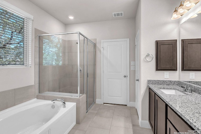 bathroom with vanity, shower with separate bathtub, and tile patterned flooring