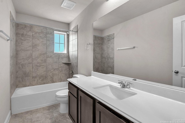 full bathroom featuring toilet, tiled shower / bath combo, a textured ceiling, and vanity