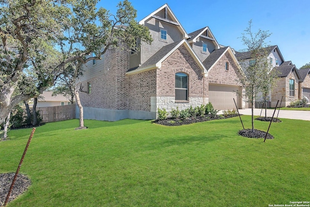 view of front of home with a front yard and a garage