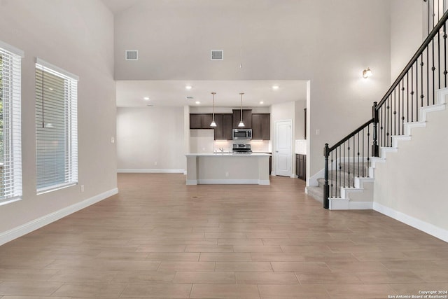 unfurnished living room with a high ceiling