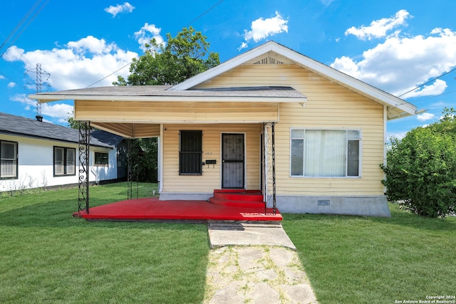 bungalow-style house with a front lawn