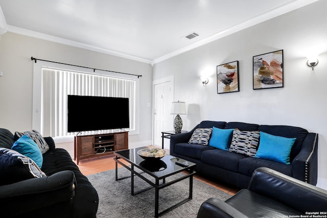 living room featuring wood-type flooring and ornamental molding