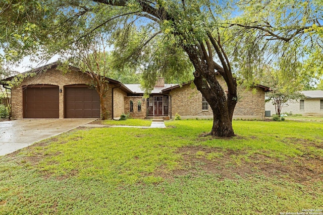 view of front of home with a garage, concrete driveway, brick siding, and a front yard