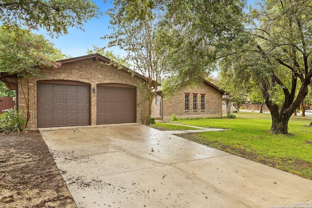 view of front of house with a garage, concrete driveway, brick siding, and a front yard