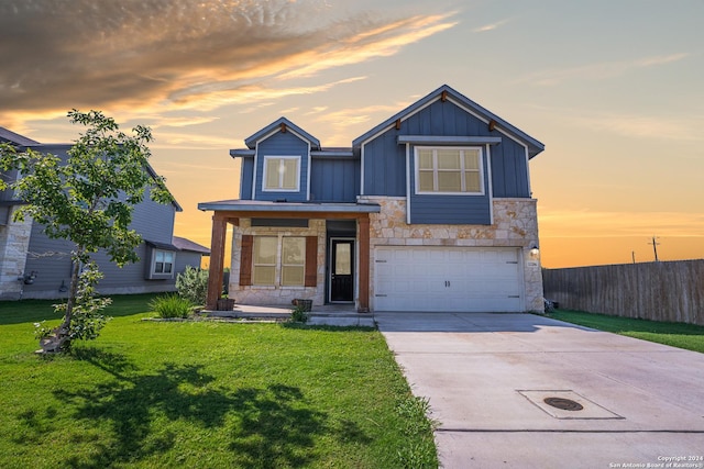 view of front of house featuring a yard and a garage