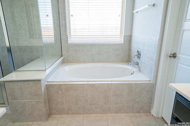 bathroom with tile patterned floors, vanity, and plus walk in shower