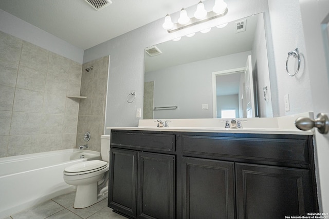 full bathroom with tiled shower / bath combo, toilet, tile patterned floors, and vanity