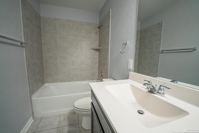 full bathroom featuring toilet, tile patterned flooring, tiled shower / bath, and vanity