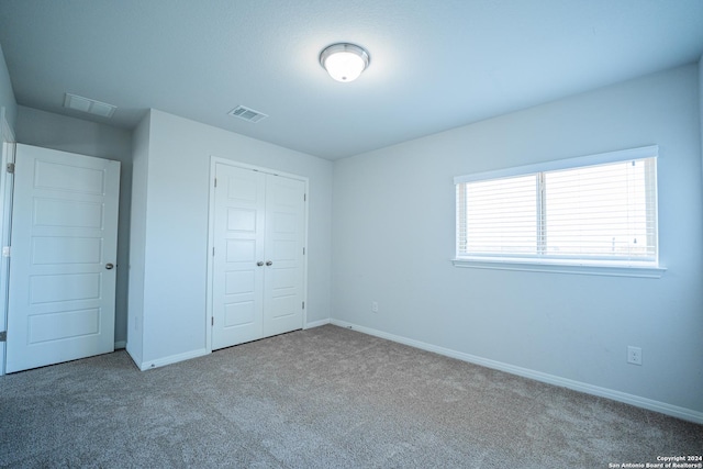 unfurnished bedroom featuring a closet and carpet flooring