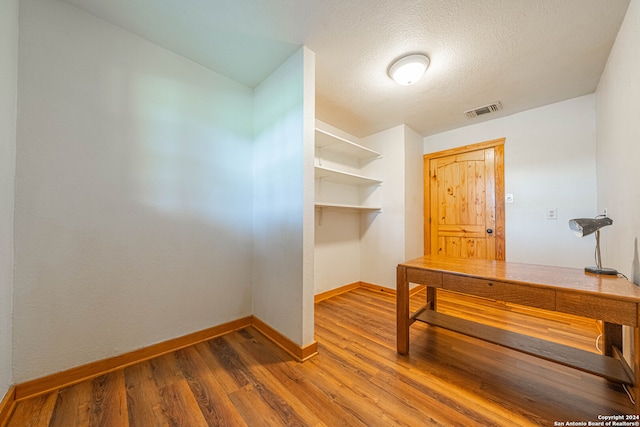 office area featuring a textured ceiling and hardwood / wood-style floors