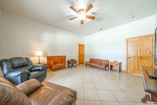 living room with ceiling fan, lofted ceiling, and light tile patterned floors