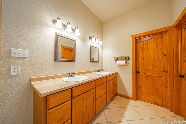 bathroom with double vanity and tile patterned floors