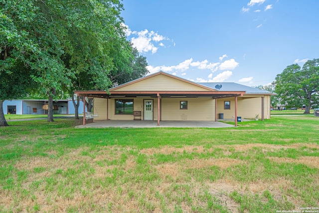 back of property featuring a yard