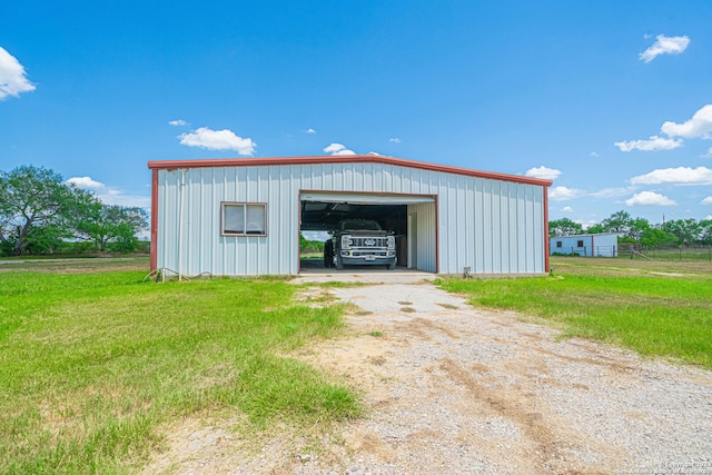 view of outbuilding with a garage and a yard