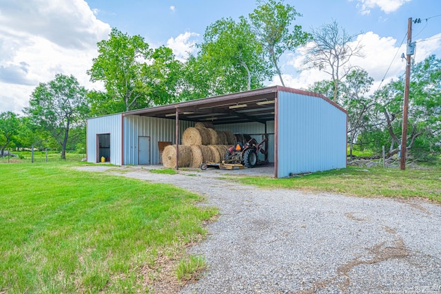 view of outbuilding featuring a lawn