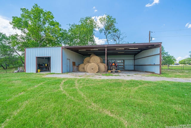 view of outbuilding featuring a yard and a carport