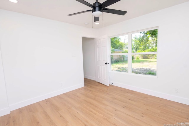 empty room with ceiling fan and light wood-type flooring