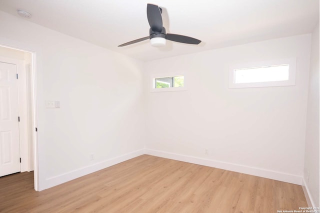 spare room with hardwood / wood-style floors and ceiling fan