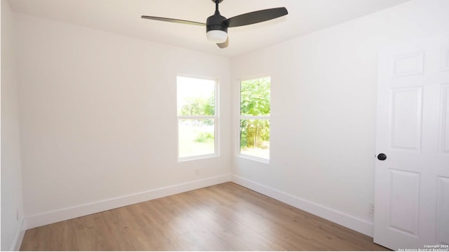 empty room with hardwood / wood-style flooring and ceiling fan