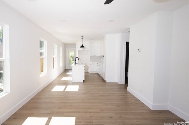 interior space with sink and light hardwood / wood-style flooring