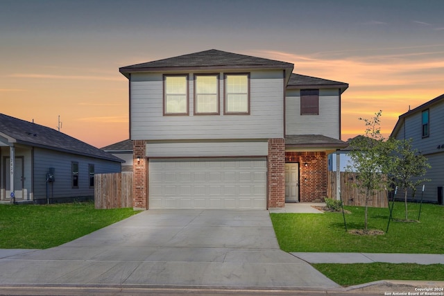 view of property featuring a garage and a yard