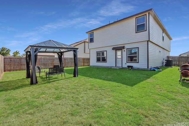 back of house featuring a gazebo, a yard, and central AC