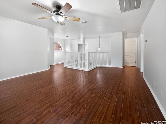 unfurnished living room featuring ceiling fan and dark hardwood / wood-style flooring