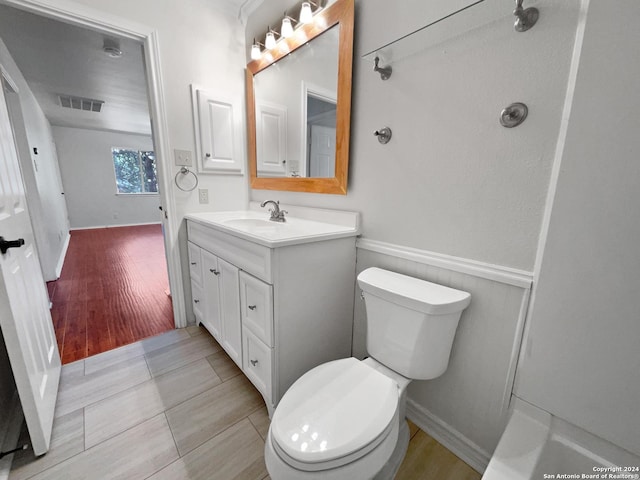 bathroom with vanity, hardwood / wood-style flooring, and toilet