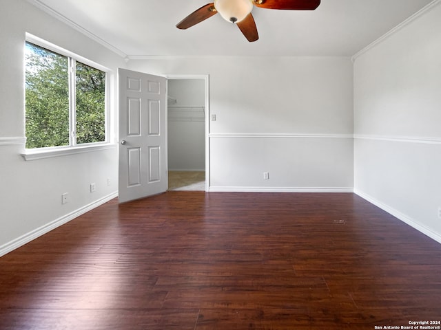 unfurnished room with ornamental molding, dark hardwood / wood-style flooring, and ceiling fan