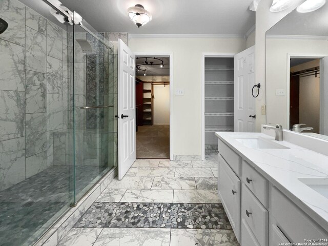 bathroom featuring vanity, a shower with door, crown molding, and tile patterned flooring