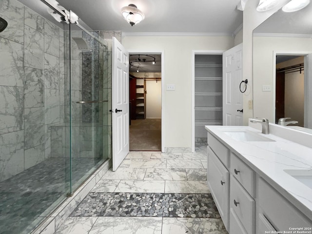 bathroom featuring a shower with door, ornamental molding, and vanity