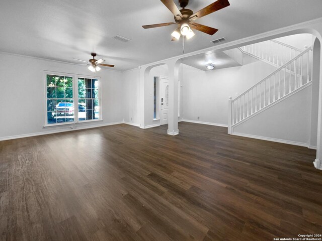 unfurnished living room featuring ceiling fan, crown molding, and dark hardwood / wood-style flooring