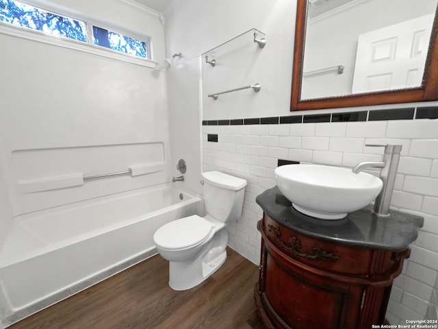 full bathroom featuring toilet, vanity, tile walls,  shower combination, and wood-type flooring