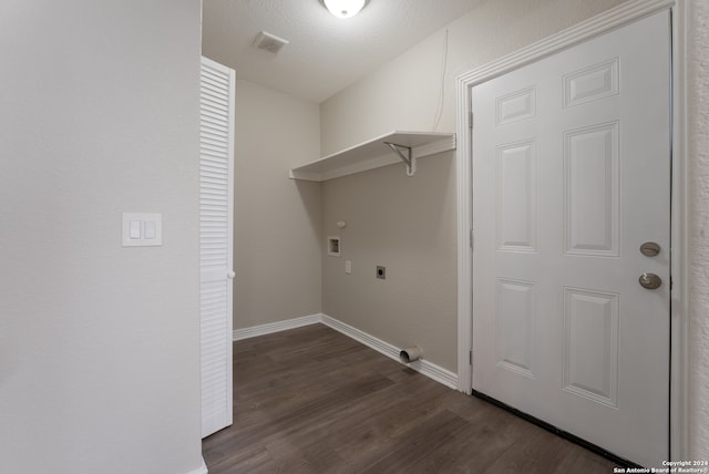 clothes washing area featuring hookup for an electric dryer, dark hardwood / wood-style floors, hookup for a washing machine, and a textured ceiling