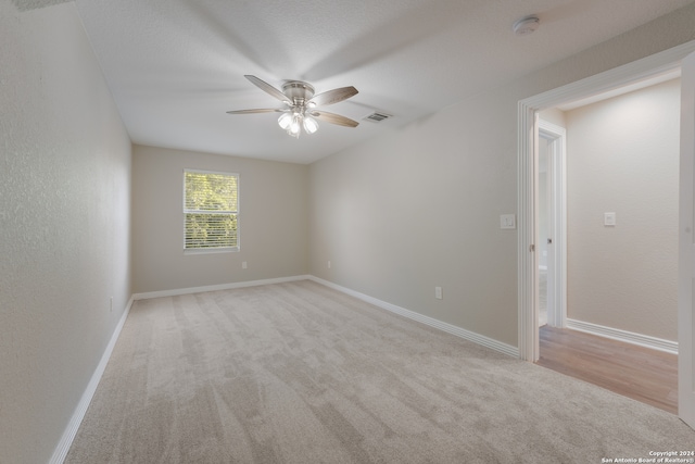 empty room with light carpet and ceiling fan