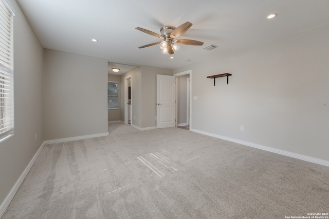 carpeted empty room featuring ceiling fan