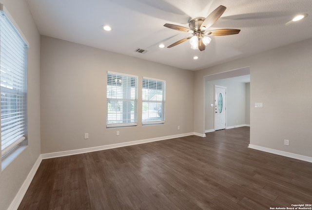 empty room featuring ceiling fan and dark hardwood / wood-style floors